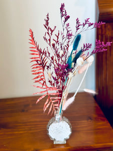 Stylish mini dry flowers in a shell glass vase