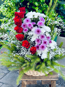 Basket of red roses and chrysanthemums