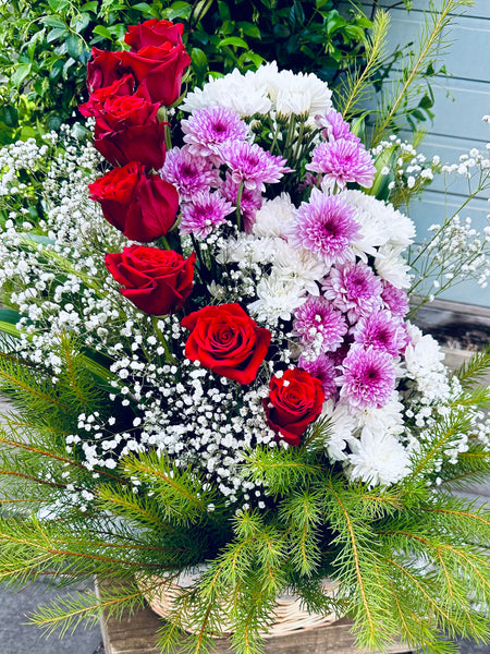 Basket of red roses and chrysanthemums