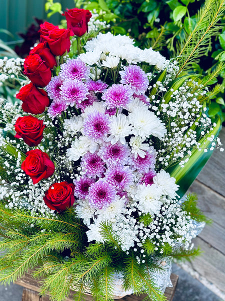 Basket of red roses and chrysanthemums