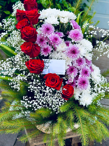 Basket of red roses and chrysanthemums