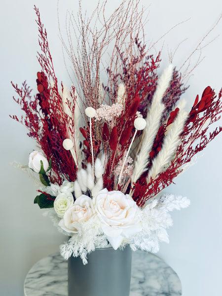 Pink roses, ranunculus with red and white dry flowers