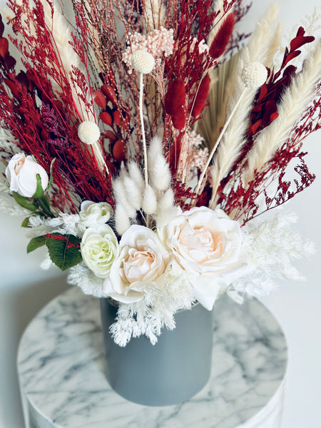 Pink roses, ranunculus with red and white dry flowers