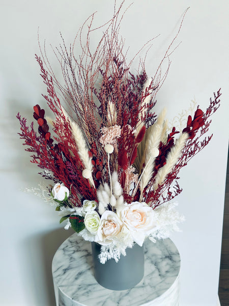 Pink roses, ranunculus with red and white dry flowers