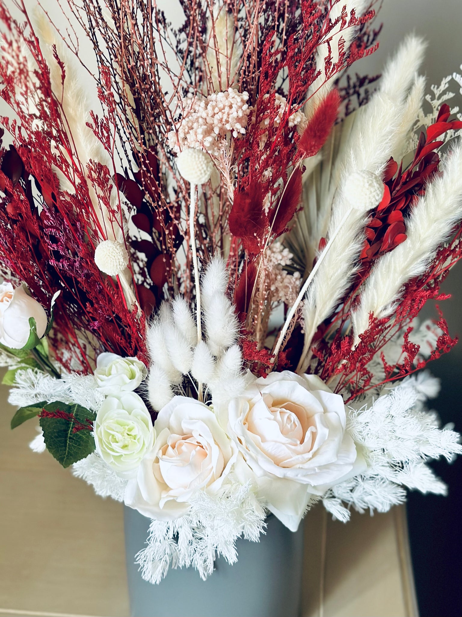 Pink roses, ranunculus with red and white dry flowers