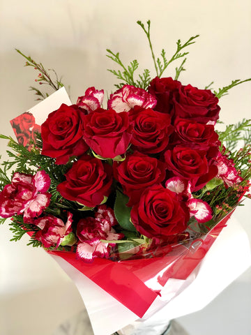 Romantic red rose and carnation wrapped bouquet