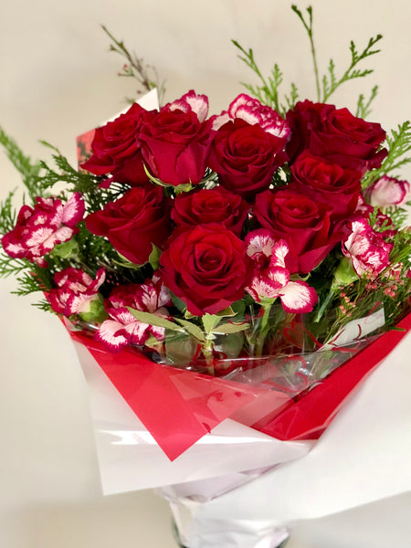 Romantic red rose and carnation wrapped bouquet