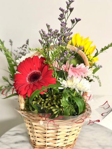 Basket of gerberas and sunflowers