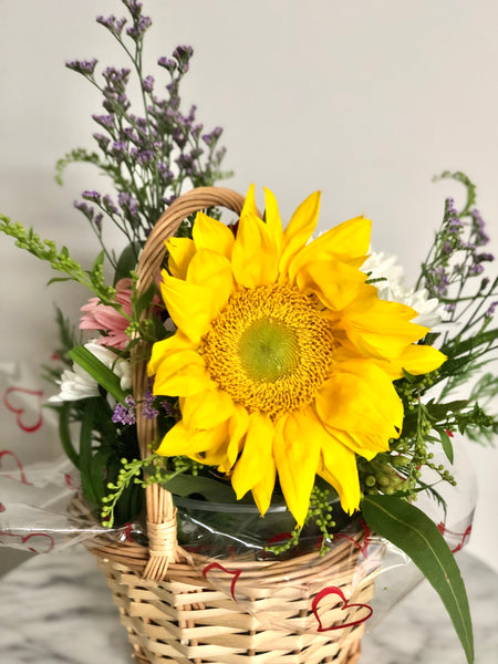 Basket of gerberas and sunflowers