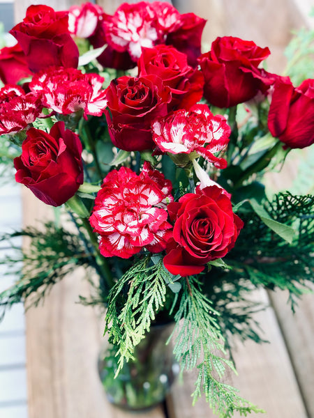 Red rose carnation and pine bouquet